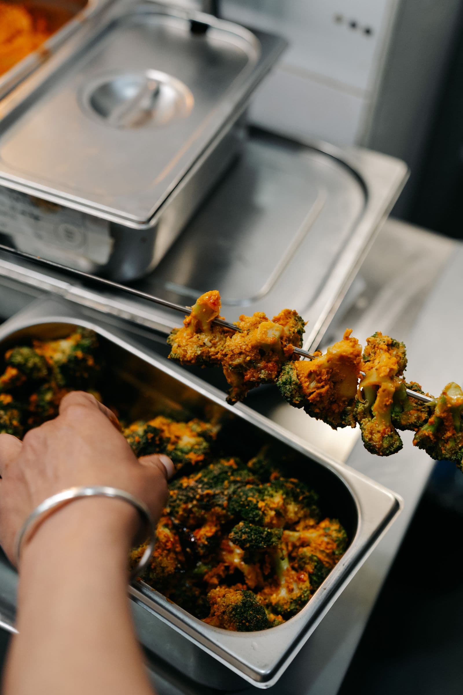 Chef Nand Kishor Semwal plating a dish in the Koyal kitchen